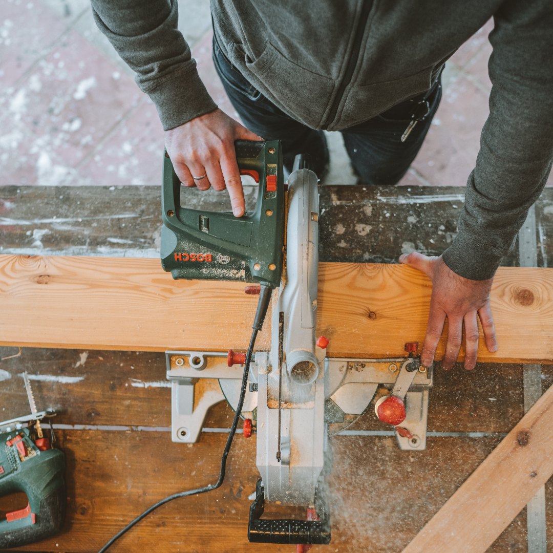 Handyman cutting wood
